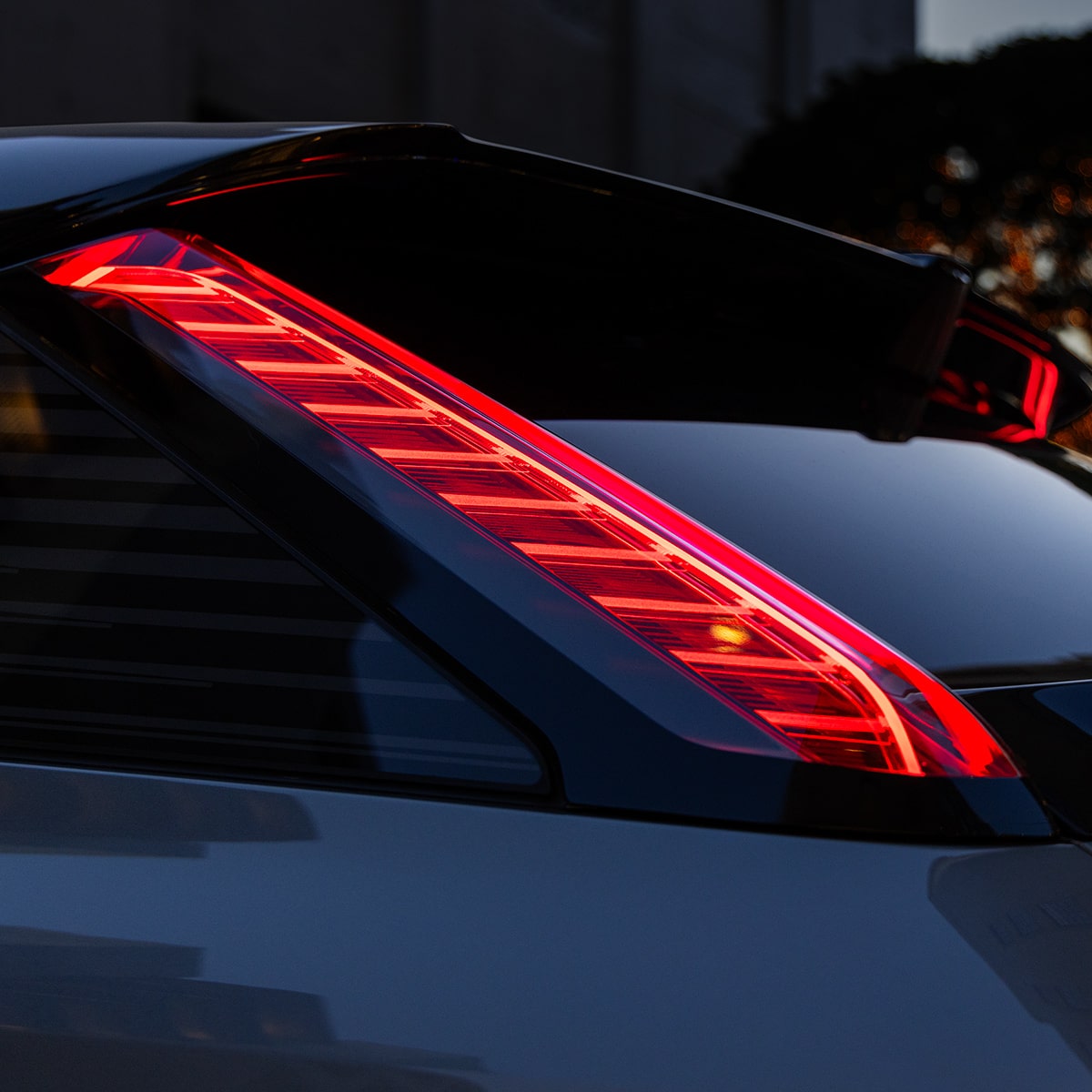 Close-up of a Cadillac's Tail Light On at Night