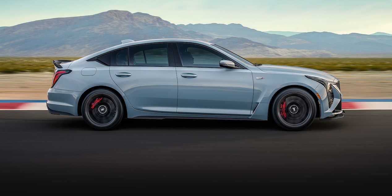 Profile View of the Light Blue Cadillac CT5-V Blackwing Parked on a Race Track Overlooking the Mountains
