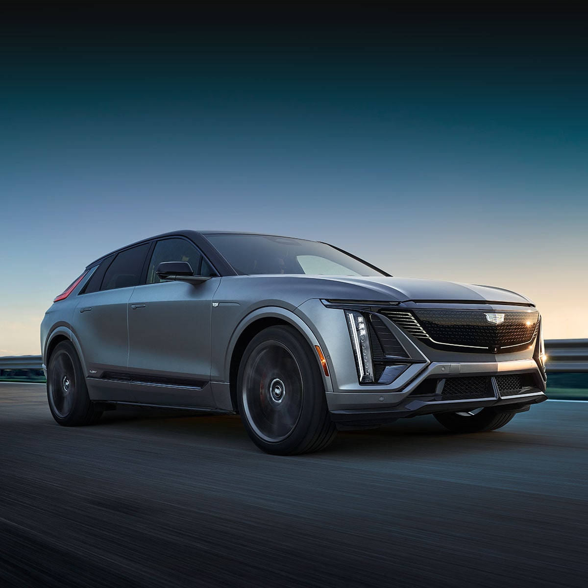 Low Three-Quarter View of the 2026 Cadillac LYRIQ-V Driving Down the Road