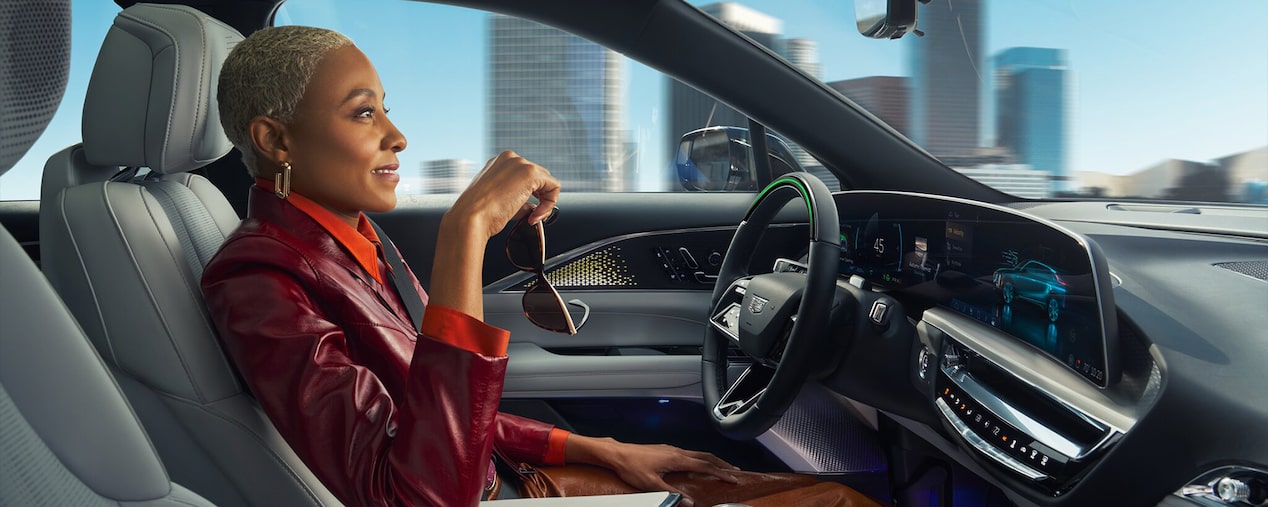 Passenger View of a Woman Using Super Cruise Hands-free Driving Technology in Her Cadillac