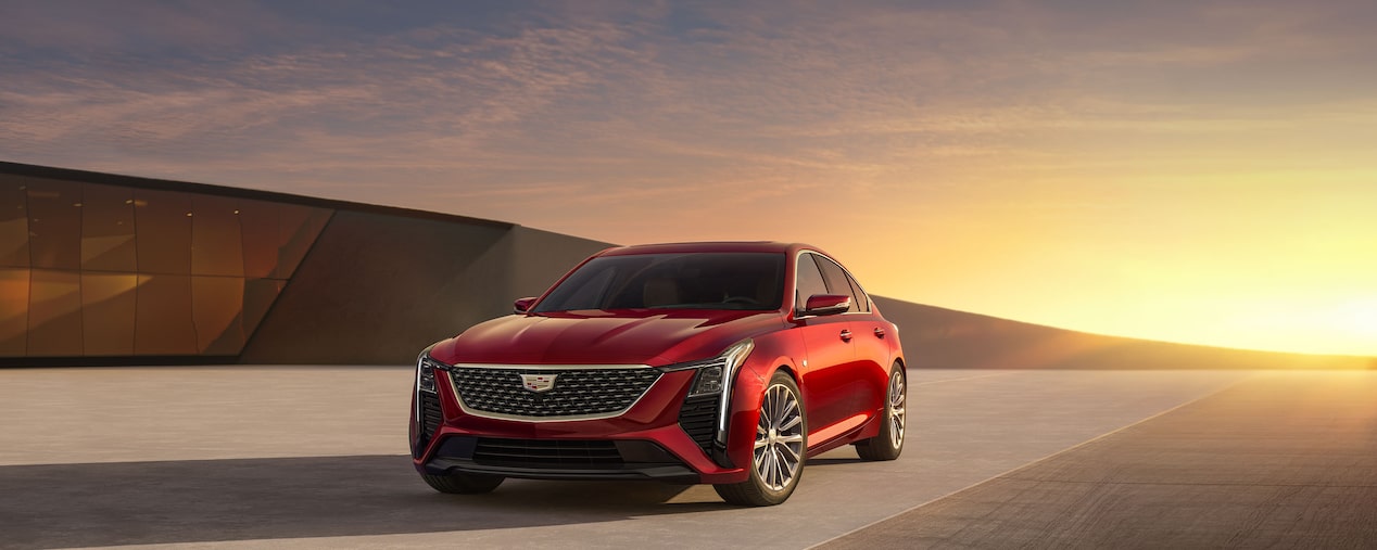 2025 Cadillac CT5 Premium Luxury Trim Parked Near Modern Building With The Sunset Behind