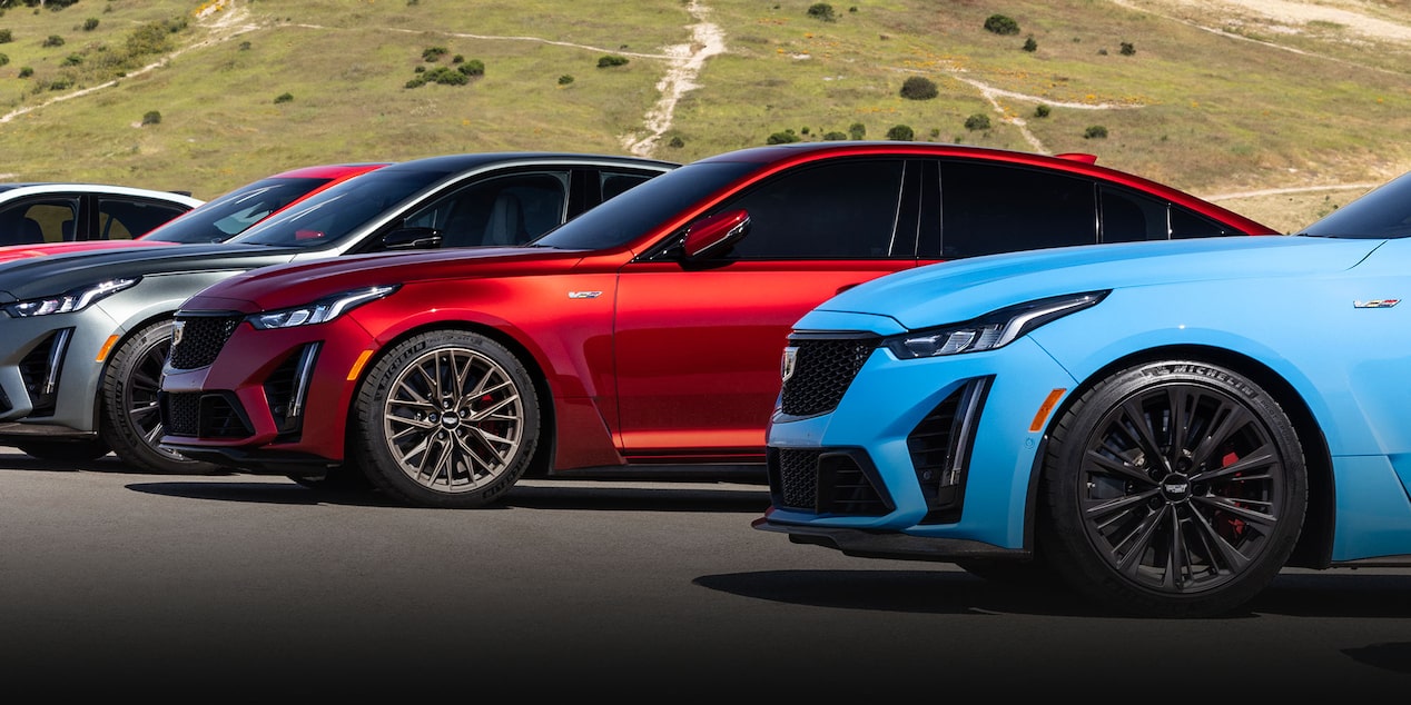 Cadillac V-Series Lineup Parked with Mountain Displayed in Background