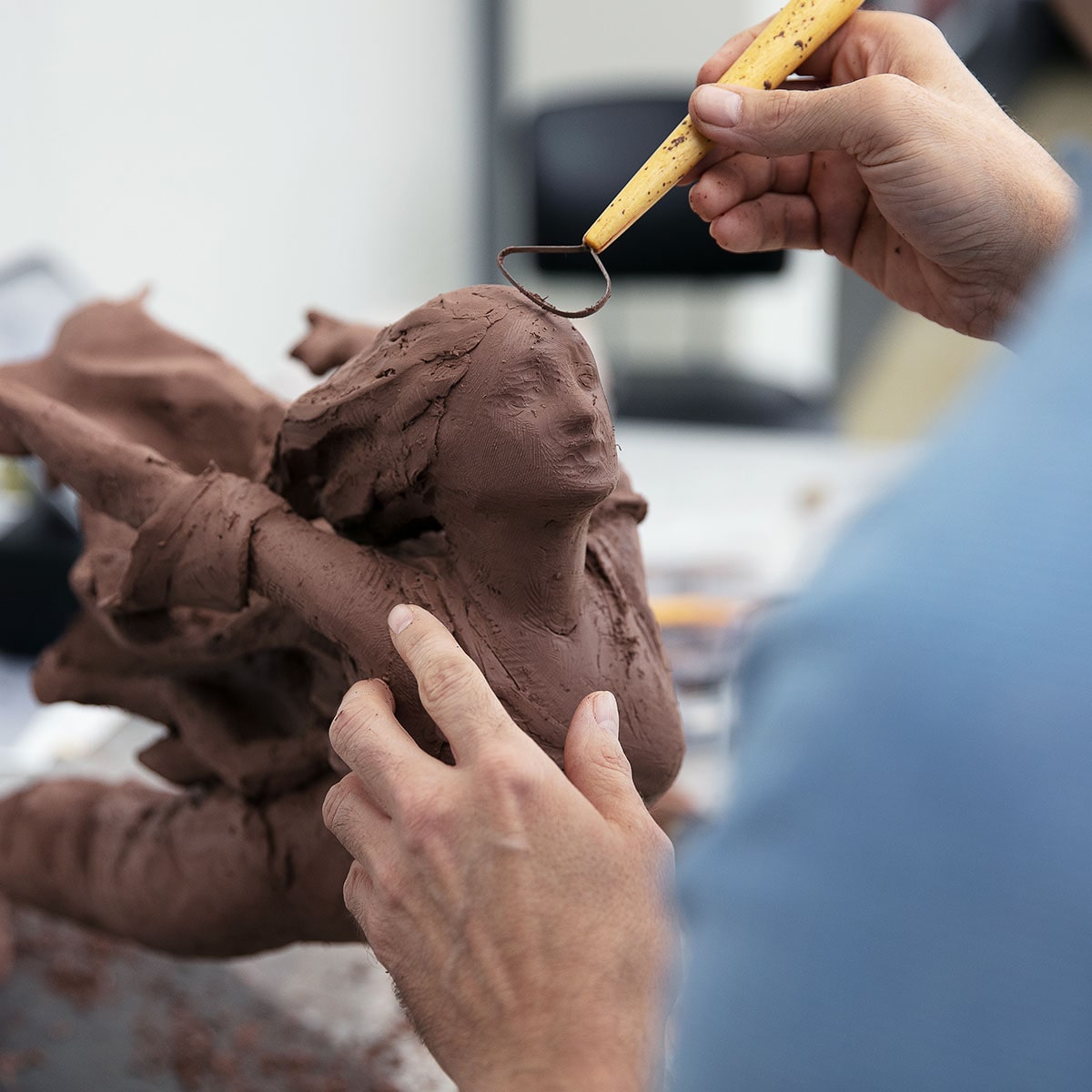 Artist Carving the Cadillac Goddess Figure Out of Clay