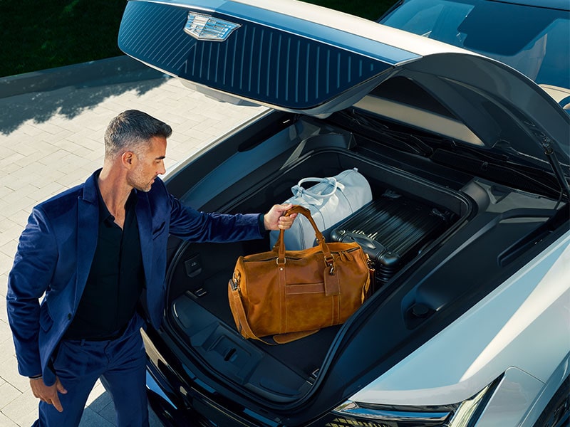 Man Placing His Bags in the 2025 Cadillac Escalade IQ etruck