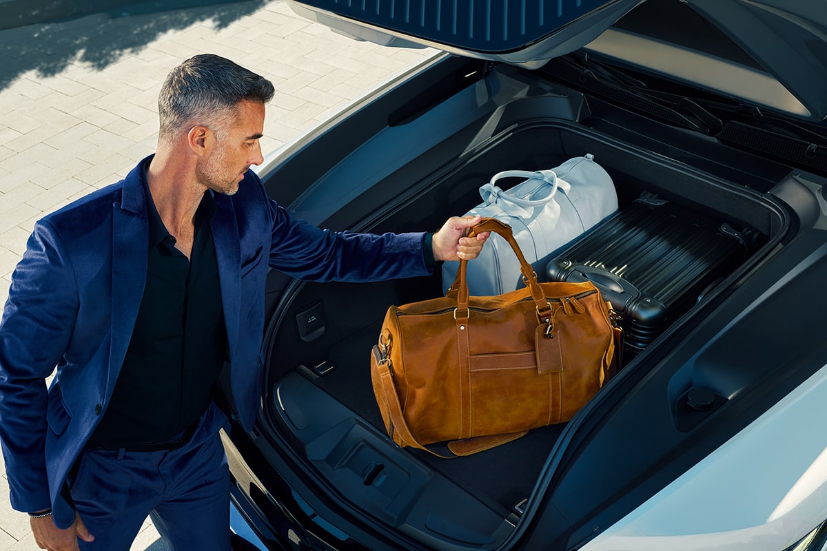 Man A Man Placing His Bags in the 2026 ESCALADE IQL eTrunk