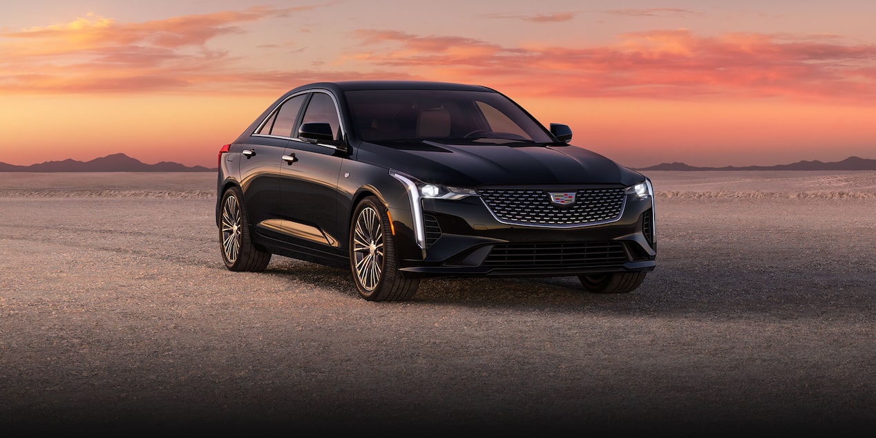 Three-quarter View of a 2024 Cadillac CT4 Parked in the Open Desert During Sunset