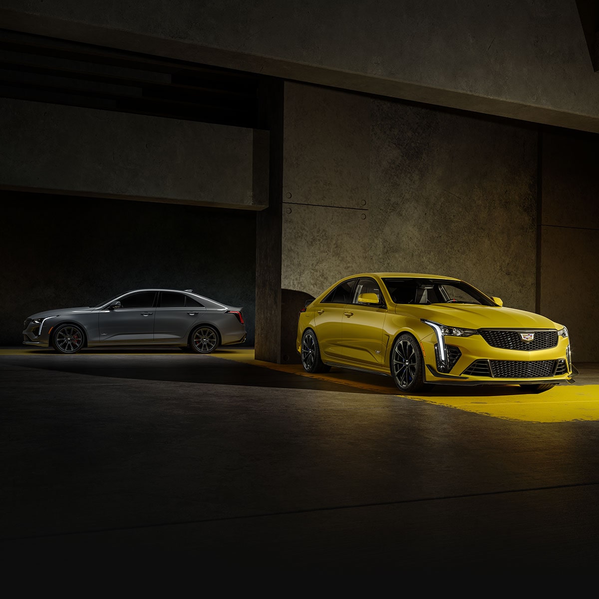 Two 2025 Cadillac CT4-V Sedans Parked in a Parking Garage