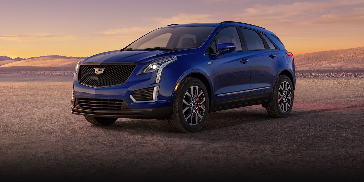 Three-quarter View of a Blue 2024 Cadillac XT5 Parked in the Desert