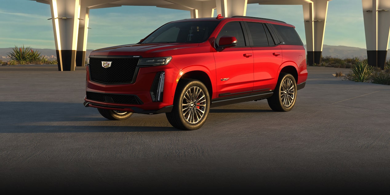 Three-quarter View of a Red 2025 Cadillac Escalade-V Parked Under an Overpass