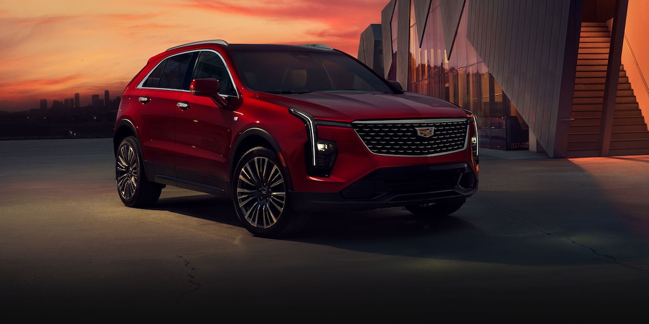 Three-quarter View of a Red 2025 Cadillac XT4 Parked During Dusk