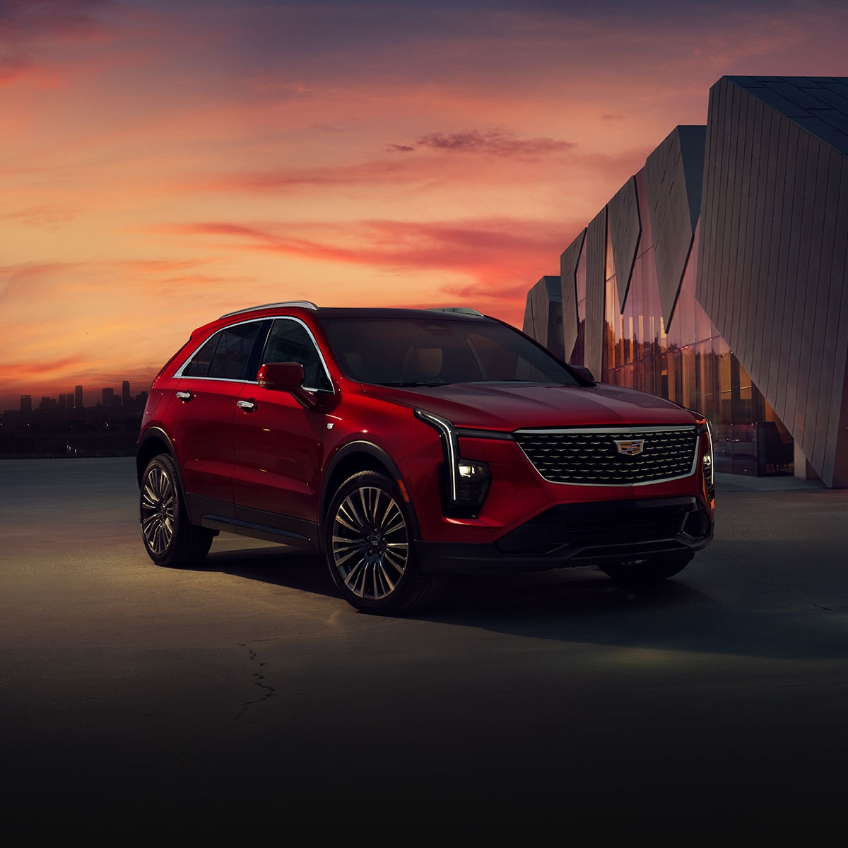 Three-quarter View of a Red 2025 Cadillac XT4 Parked During Dusk